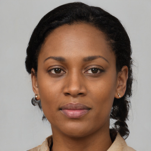Joyful black young-adult female with medium  black hair and brown eyes