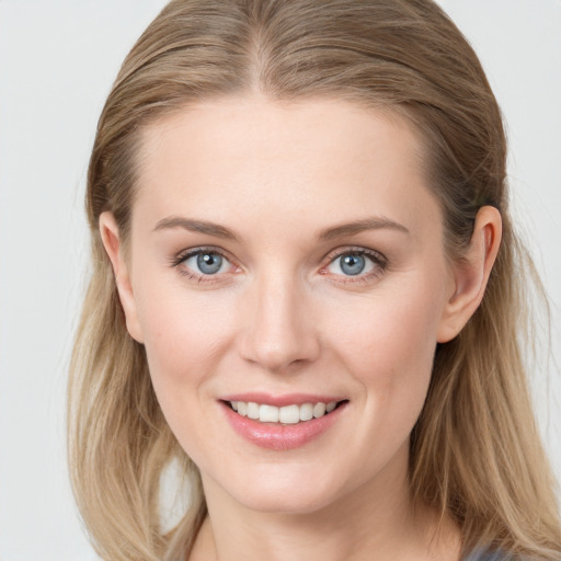 Joyful white young-adult female with long  brown hair and blue eyes