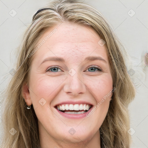 Joyful white young-adult female with long  brown hair and blue eyes