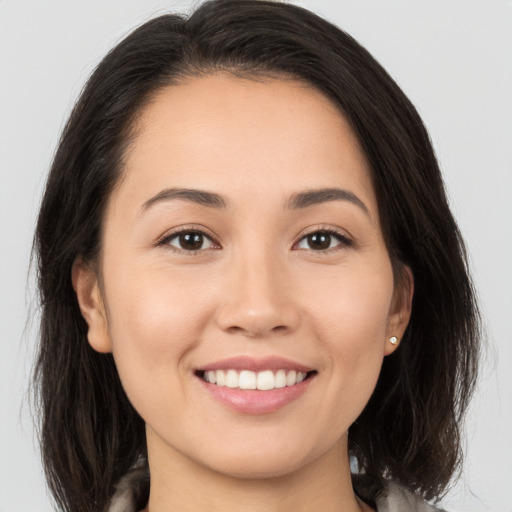 Joyful white young-adult female with medium  brown hair and brown eyes