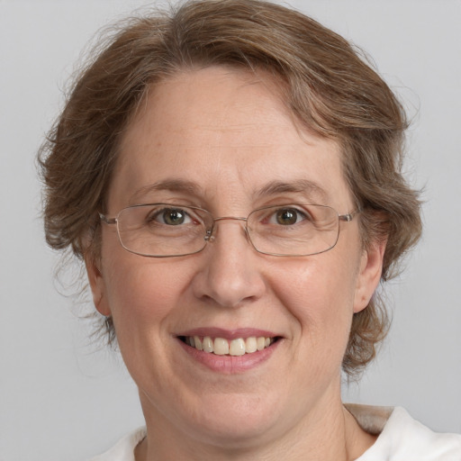 Joyful white middle-aged female with medium  brown hair and blue eyes