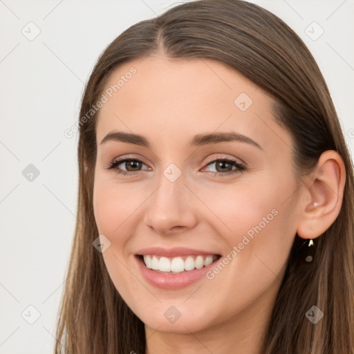 Joyful white young-adult female with long  brown hair and brown eyes