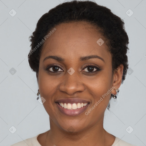 Joyful black young-adult female with short  black hair and brown eyes