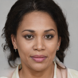 Joyful latino adult female with medium  brown hair and brown eyes