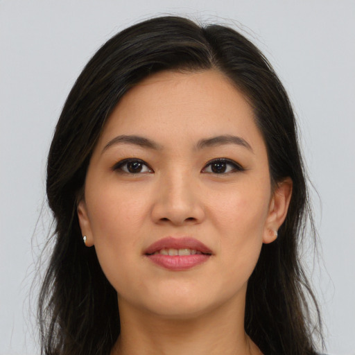 Joyful asian young-adult female with long  brown hair and brown eyes