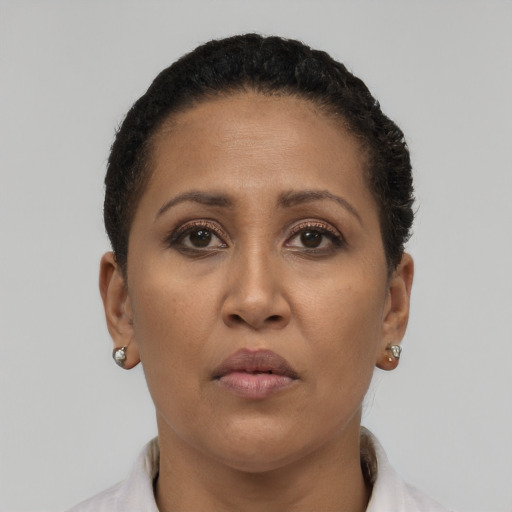 Neutral latino adult female with short  brown hair and brown eyes
