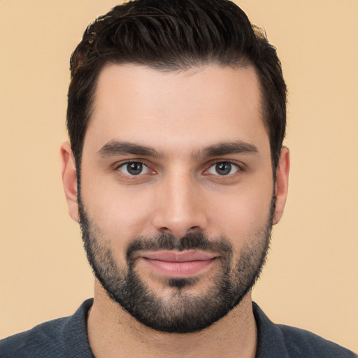 Joyful white young-adult male with short  black hair and brown eyes