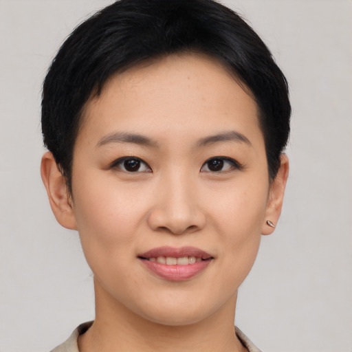 Joyful asian young-adult female with short  black hair and brown eyes