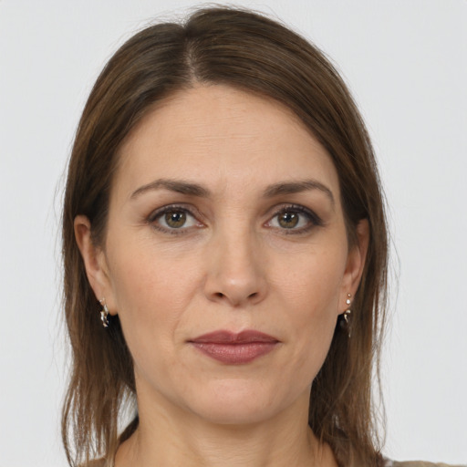 Joyful white adult female with long  brown hair and grey eyes