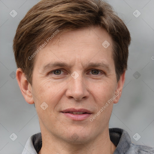 Joyful white adult male with short  brown hair and grey eyes