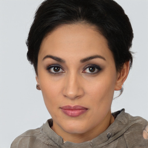 Joyful latino young-adult female with short  brown hair and brown eyes