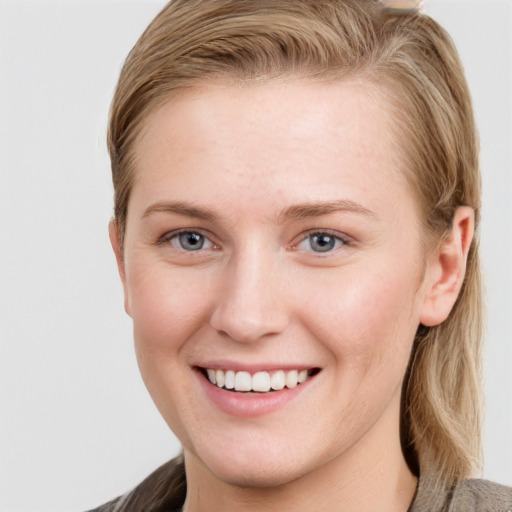 Joyful white young-adult female with long  brown hair and blue eyes