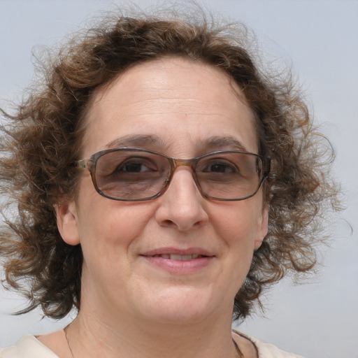 Joyful white adult female with medium  brown hair and blue eyes