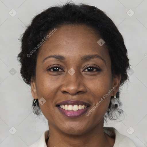 Joyful black adult female with medium  brown hair and brown eyes