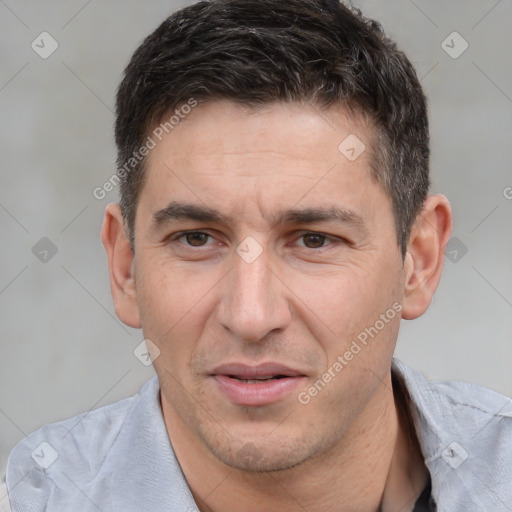 Joyful white adult male with short  brown hair and brown eyes