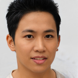 Joyful asian young-adult male with short  brown hair and brown eyes