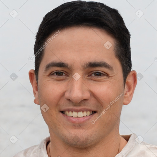 Joyful white young-adult male with short  black hair and brown eyes