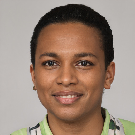Joyful black young-adult female with short  black hair and brown eyes
