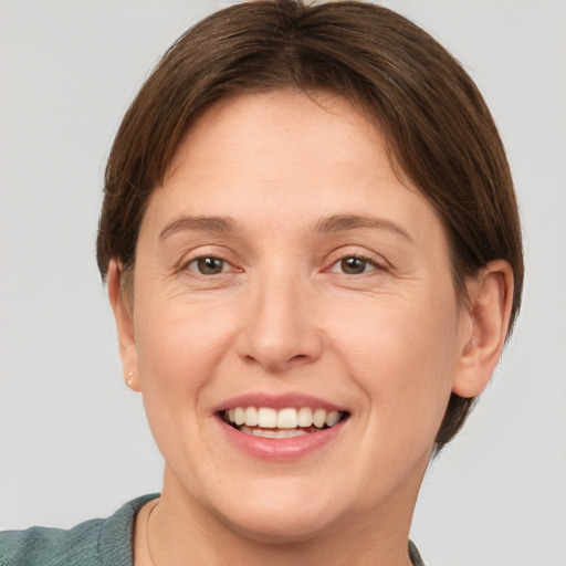 Joyful white adult female with short  brown hair and grey eyes