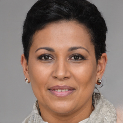Joyful latino adult female with short  brown hair and brown eyes