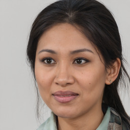 Joyful latino young-adult female with medium  brown hair and brown eyes