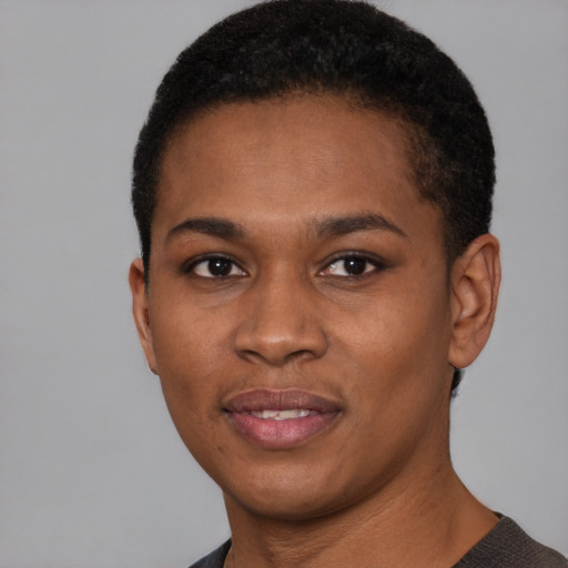 Joyful black young-adult female with short  black hair and brown eyes