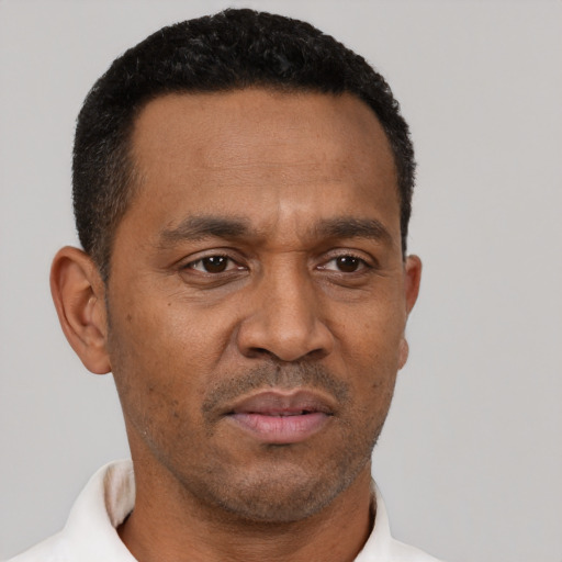 Neutral latino adult male with short  black hair and brown eyes