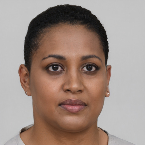 Joyful black young-adult female with short  brown hair and brown eyes