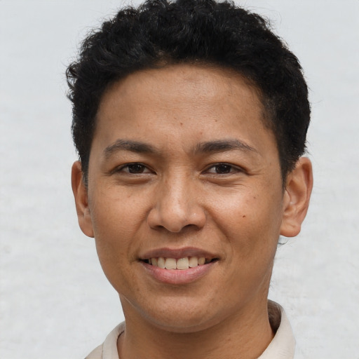 Joyful asian young-adult male with short  brown hair and brown eyes