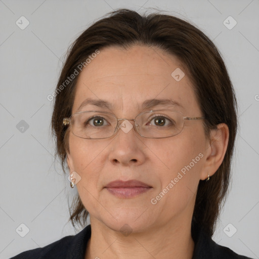 Joyful white adult female with medium  brown hair and brown eyes