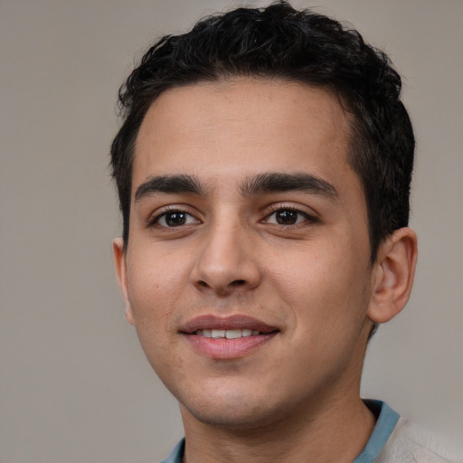 Joyful white young-adult male with short  black hair and brown eyes