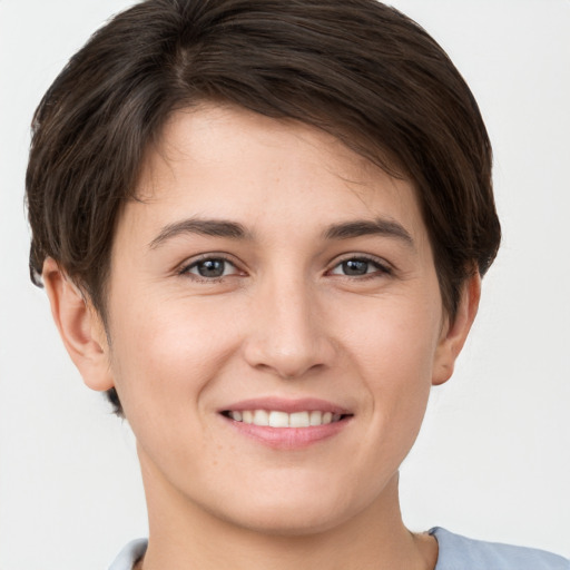 Joyful white young-adult female with short  brown hair and brown eyes