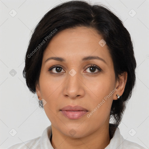 Joyful latino adult female with medium  brown hair and brown eyes