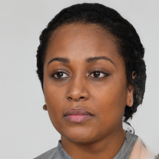Neutral black adult female with short  black hair and brown eyes