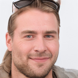 Joyful white young-adult male with short  brown hair and blue eyes