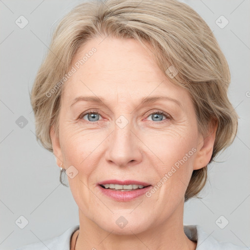 Joyful white adult female with medium  brown hair and blue eyes