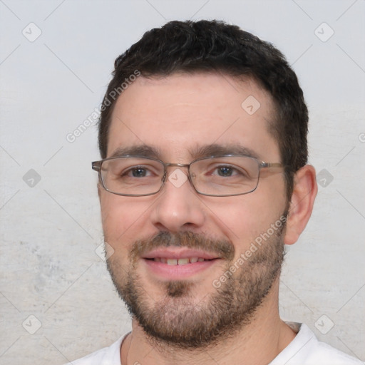 Joyful white young-adult male with short  black hair and brown eyes