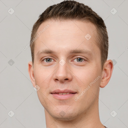 Joyful white young-adult male with short  brown hair and grey eyes