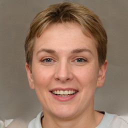 Joyful white adult female with short  brown hair and grey eyes