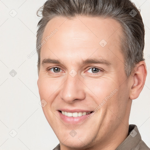 Joyful white adult male with short  brown hair and brown eyes