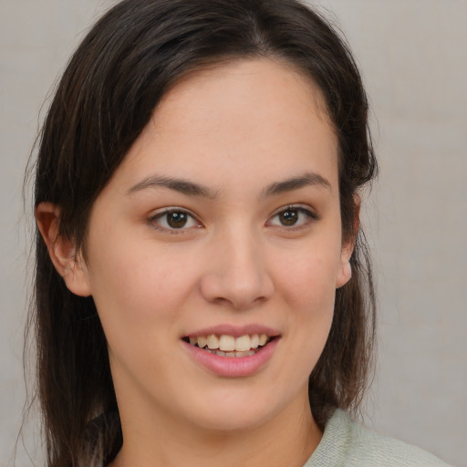 Joyful white young-adult female with medium  brown hair and brown eyes