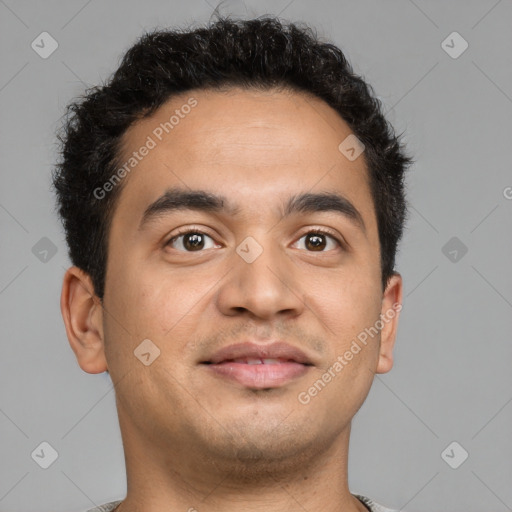 Joyful latino young-adult male with short  brown hair and brown eyes