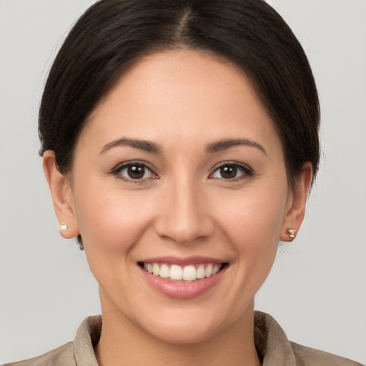 Joyful white young-adult female with short  brown hair and brown eyes