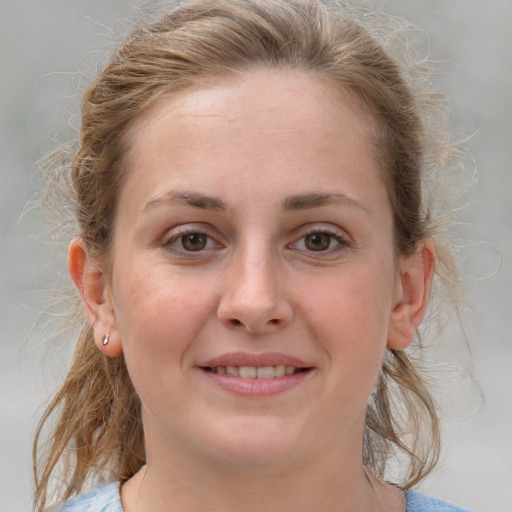 Joyful white young-adult female with medium  brown hair and blue eyes