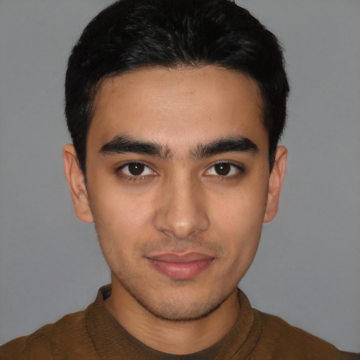 Joyful latino young-adult male with short  black hair and brown eyes