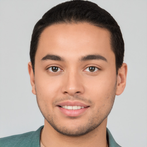 Joyful white young-adult male with short  black hair and brown eyes