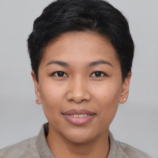 Joyful asian young-adult female with short  black hair and brown eyes