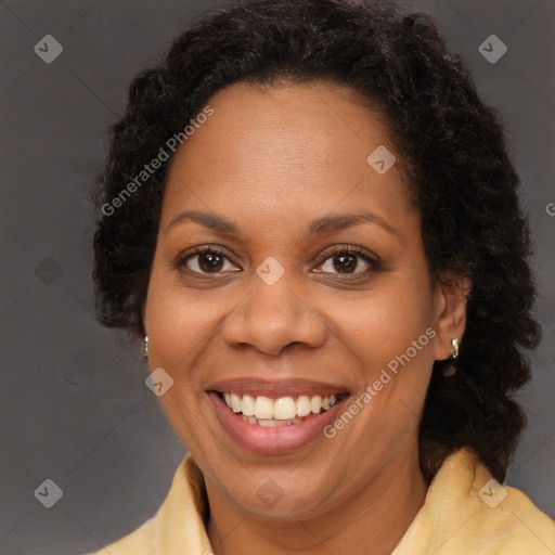 Joyful black adult female with long  brown hair and brown eyes