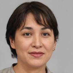 Joyful white adult female with medium  brown hair and brown eyes