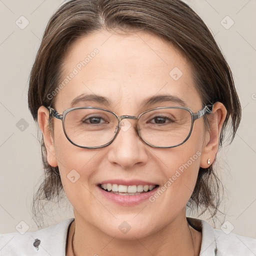 Joyful white adult female with medium  brown hair and brown eyes